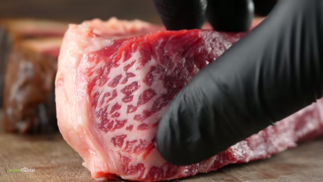 Seasoning the aged steaks before grilling