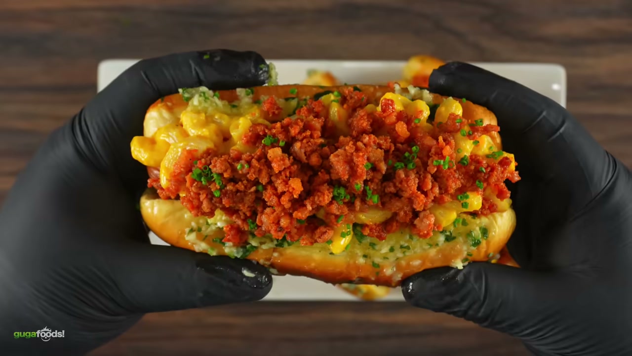 Finished mac and cheese hot dog being eaten - captures the indulgent side dish a