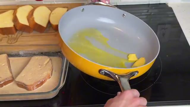 French toast cooking in butter in the pan, golden and sizzling