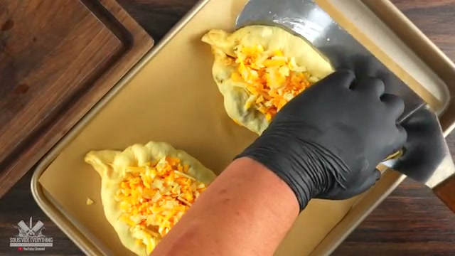 Finished steak pastry pockets coming out of the oven with melted cheese, the com